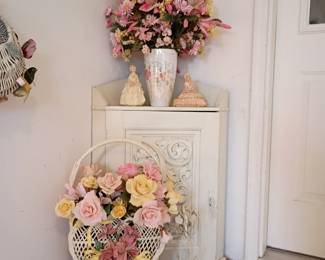Corner cabinet with hand carved detailing on door.