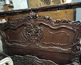 Headboard and footboard are intricately detailed.