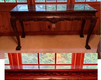 Chippendale style mahogany console table with claw feet and a glass top