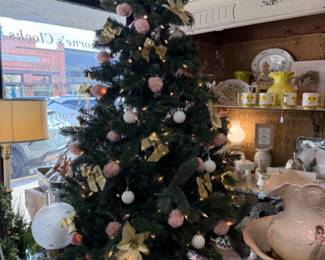 Small beautifully decorated gold, pink and white lit Christmas tree.