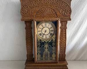 Antique Ornate Carved Wood Mantel Clock with Roman Numeral Dial and Decorative Glass Panel