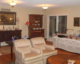 Den furniture, including two easy chairs, a mahogany buffet, and a cherry cupboard