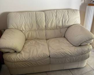 Cream leather loveseat
64” across x 37” tall x 36” deep