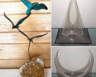 A vintage Curtis Jere sculpture of three birds in flight on a stone base, and two pieces of Sompex Germany lucite string art