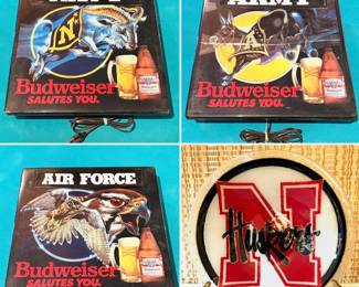 Three vintage Budweiser "Salutes You" lighted sign collectibles, and a Peggy Karr Husker plate.