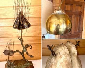 A sculpture by the Iranian-American artist Bijan Bahar, a vintage mid-century modern brass arc floor lamp and Curtis Jere mountain climber brass and rock bookends.