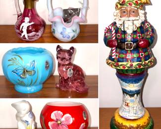 A Mary Gregory style cranberry glass cruet, a Fenton Art Glass basket, a Fenton Limited Edition turquoise glass rose bowl with a hand-painted butterfly design, a vintage Fenton Art Glass Empress Rose sitting cat figurine, a vintage Fenton Glass White Satin Grooming Cat figurine, a Robert Lagestee Selenium Red Bowl with Lavender Triple Heart Blossoms and a Jim Shore Heartwood Creek "Season Sweets" Santa Nutcracker figurine.