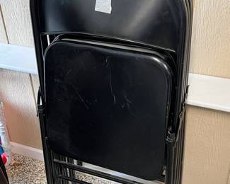 4 black folding chairs