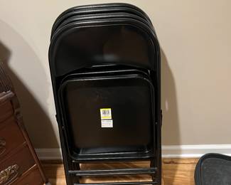 4 black folding chairs