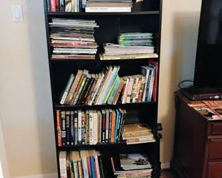 Bookshelf with tons of books and magazines