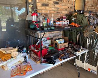 An entire room filled with military uniforms, ammo, hunting clothing, camo, coats, long johns and all you could need for outdoors