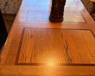 Vintage solid wood dining table with one leaf and four rolling chairs