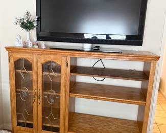 Entertainment center w/shelves & leaded glass doors. 