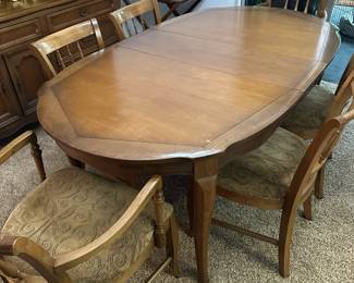 Dining room table with six chairs and two leaf inserts (not shown)