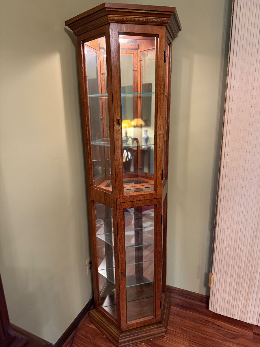 - Tall curio cabinet with glass shelving, cherry finish