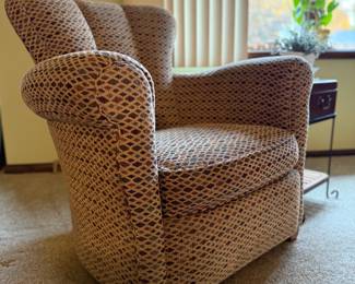 Comfortable  armchair featuring a sculpted back, rolled arms, and tapered wood legs. Upholstered in a soft diamond-patterned fabric in tones of beige, navy, and burgundy — a versatile piece that complements both traditional and transitional décor.