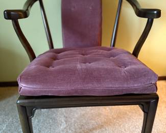 Vintage accent chair featuring a sculptural dark wood frame with graceful horseshoe arms and a plush, tufted mauve velvet cushion. Perfect as an accent, desk, or vanity chair.