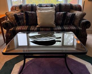 Comfortable plaid sofa with glass coffee table