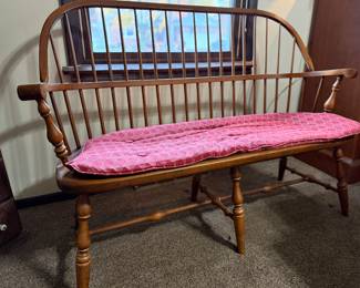 Beautiful solid wood Windsor-style bench with turned legs and spindled back. Comes with a cushioned red seat pad in a diamond pattern. Perfect for an entryway, hallway, or bedroom accent piece.