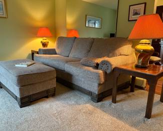 Stylish and comfortable gray upholstered sofa paired with a matching oversized ottoman.