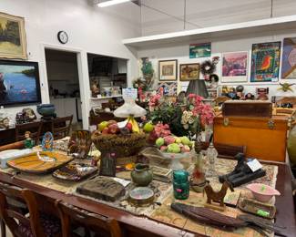 Dining table and chairs with pottery and art