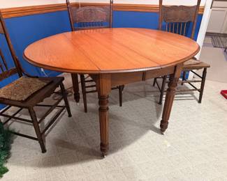 Antique drop-leaf round dining table, antique caned chairs