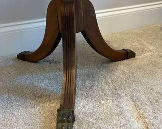 C85 - $85. Round Wooden Side Table with Brass Feet. Measures 20" round x 25.75" tall. Top does have some water rings. Solid wood.