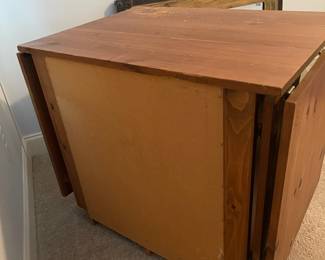 C6 - $50. Sewing Machine Table. Measures 33" wide x 24" deep x 28" tall. Each leaf adds 24". There is wear on the surface. Cabinet has 5 drawers, 1 door on hinges. (Needs minor work to reattach one leaf.)