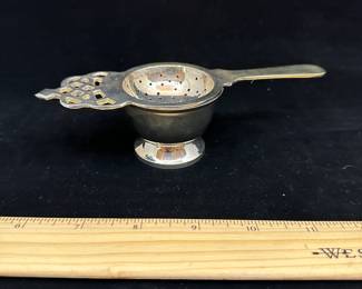 J38 - $10. Unmarked Silver plated tea strainer.