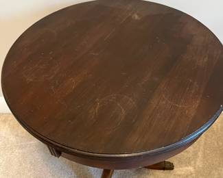 C85 - $85. Round Wooden Side Table with Brass Feet. Measures 20" round x 25.75" tall. Top does have some water rings. Solid wood.