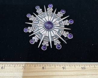 J41 - $400. Amethyst & Sterling Brooch or Pendant. Believed to be a William Spratling Design. Back is Stamped "Mexico Silver" qith a fancy M. Excellent vintage condition! Measures 3" across.