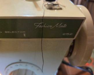 #36	Singer Fabric Mate sewing machine in cabinet and chair	 $30.00