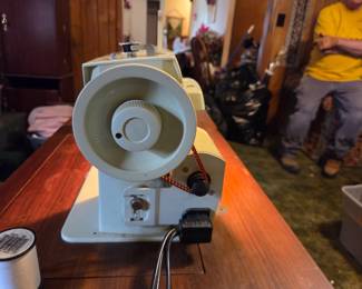 #36	Singer Fabric Mate sewing machine in cabinet and chair	 $30.00