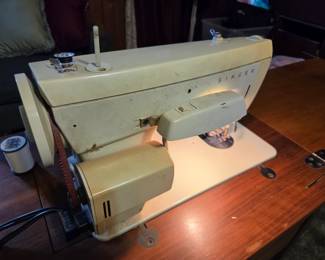 #36	Singer Fabric Mate sewing machine in cabinet and chair	 $30.00