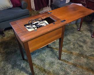 #36	Singer Fabric Mate sewing machine in cabinet and chair	 $30.00