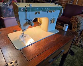 #36	Singer Fabric Mate sewing machine in cabinet and chair	 $30.00