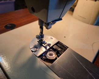 #36	Singer Fabric Mate sewing machine in cabinet and chair	 $30.00