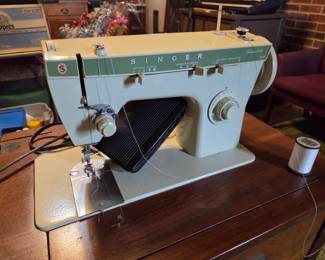 #36	Singer Fabric Mate sewing machine in cabinet and chair	 $30.00