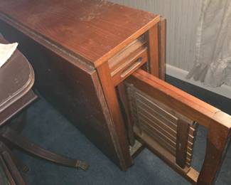 Foldable table with 4 folding chairs stored inside