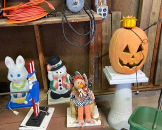 Holiday decor including the couple blow molds and other statues that are interchangeable on this bird bath base