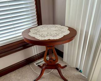 vintage Mersman lyre harp side table with a round top and pedestal base