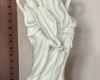 vintage porcelain figurine of Kwan Yin, also known as Guanyin, the Chinese Goddess of Compassion and Mercy. It is also referred to as the "Mother of Mercy"