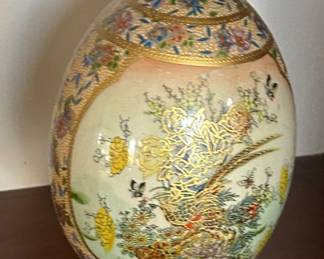 vintage Satsuma-style porcelain egg on a wooden stand