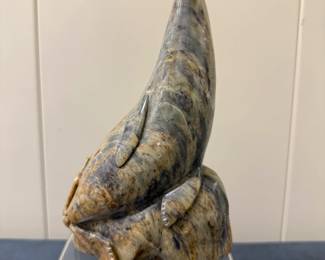 Inuit Figurine - Sea Lion | Stone carving of a sea lion perched upright on a rock, leaning toward the sky. 
Soapstone carving
Signed by artist (bottom): "Junior Snook"
Titled by artist: N/A
Numbered by artist: N/A