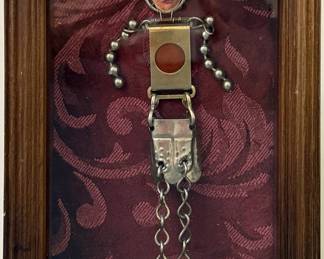 Marita Dingus (American, 1956-) Mixed Media Sculpture | Metal figure made from wire, chains, and flat metal pieces.
Mixed media
Framed (gold) and matted (burgundy fabric)
Signed by artist: N/A
Titled by artist: N/A
Numbered by artist: N/A -  h. 8 x w. 5 in (Frame)