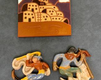 (3pc) Ceramic Tiles - Southwestern Pueblo & Others | Ceramic tiles, including: Southwestern tile trivet from Territorial Tiles, Santa Fe, depicting adobe homes in a "Pueblo" design.
Ceramic tile from Moravian Pottery and Tile Works (Pennsylvania) of a skier from a historic series.
Ceramic tile from Moravian Pottery and Tile Works (Pennsylvania) of a bullfighter from that same series.