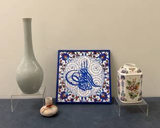 (3pc) Ceramic Pottery - Japanese, Iznik, Delft | Various types of ceramic pottery, including vases and tiles, such as: Japanese glazed porcelain vase in celadon (gray/green) color.
Nemadji Tile & Pottery Co. (Minnesota) unglazed vase with red swirl.
Iznik (Turkey) porcelain plate with calligraphy (formerly Ottoman-era Nicea).
Delft (Netherlands) polychrome jar with lid, hand-painted with a floral design.