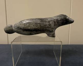 Inuit Figurine - Seal on Front Legs | Stone carving of a seal, either swimming with back fins trailing, or laying down on land. 
Soapstone carving
Signed by artist (bottom): [indistinguishable]
Titled by artist: N/A
Numbered by artist: N/A


