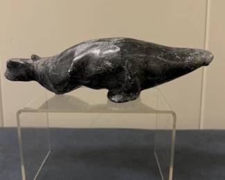 Inuit Figurine (Canadian) - Walrus | Stone carving of a walrus swimming through the water or pushing off its front flippers for forward momentum. 
Soapstone carving
Signed by artist (bottom): Numbered and contains the "igloo tag trademark" of authenticity: "Canada Inuit Art"
Titled by artist: N/A
Numbered by artist: N/A