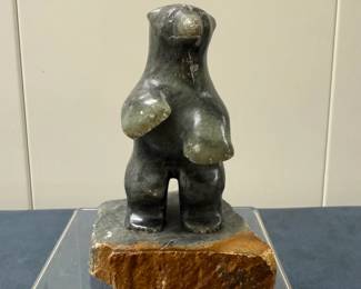 Inuit Figurine - Bear (Dark Stone) | Stone carving of a bear on hind legs (dark stone).
Soapstone carving
Signed by artist: [indistinguishable] 
Titled by artist: N/A
Numbered by artist: N/A